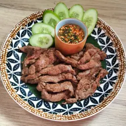Bœuf grillé et fines tranches de concombre, accompagnés d'une sauce tigre qui pleure épicée.