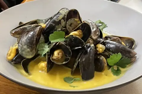 Moules à la crème, une recette simple et savoureuse. Les moules sont servies dans une sauce onctueuse, garnies de persil frais.