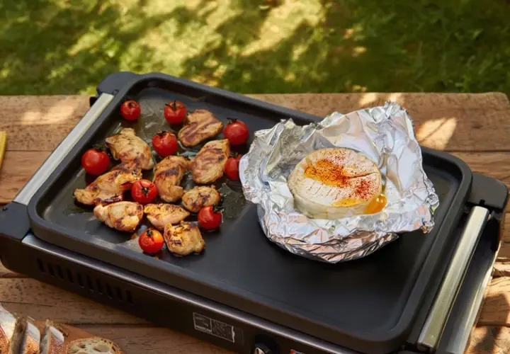 Un camembert fondant à la plancha, entouré de poulet grillé et de tomates cerises. Un délice pour un repas en plein air.