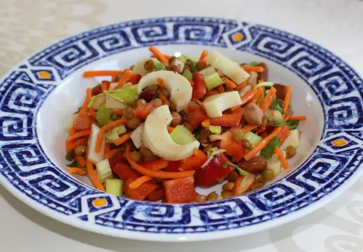 Salade colorée avec des cœurs de palmier, carottes râpées, lentilles et poivrons rouges. Un délice frais et sain.